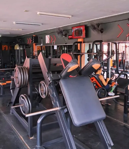 Área de musculação com equipamentos laranja da Fusion Fitness Centro